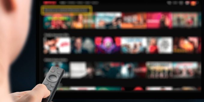 Decorative image showing a man sitting down to stream or watch television.