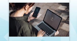 A woman looking at her laptop.